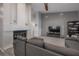 Comfortable living room featuring a modern fireplace, grey walls, and neutral furniture at 905 Clearcreek Dr, Tampa, FL 33613