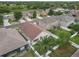 Aerial view of a home with fenced backyard and lush greenery in a residential neighborhood at 9644 Jasmine Brook Cir, Land O Lakes, FL 34638