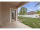 The backyard has a door, grass, a tree, a white fence and a concrete patio at 9644 Jasmine Brook Cir, Land O Lakes, FL 34638