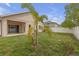 Backyard featuring lawn, landscaping, patio, privacy fence, and house exterior at 9644 Jasmine Brook Cir, Land O Lakes, FL 34638
