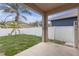 A white fence surrounds the backyard's grass, landscaping, patio and surrounding houses at 9644 Jasmine Brook Cir, Land O Lakes, FL 34638