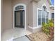 Inviting front entrance featuring a decorative glass door and elegant sidelights at 9644 Jasmine Brook Cir, Land O Lakes, FL 34638