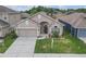 Charming single-story home with a well-manicured lawn and attached two-car garage at 9644 Jasmine Brook Cir, Land O Lakes, FL 34638