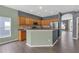 Well-lit kitchen with wooden cabinets, stainless steel appliances, and an island at 9644 Jasmine Brook Cir, Land O Lakes, FL 34638