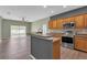 Kitchen with stainless steel appliances and breakfast bar overlooking a sunny living area at 9644 Jasmine Brook Cir, Land O Lakes, FL 34638