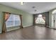 Bright living room featuring hardwood floors, large windows, and neutral wall colors at 9644 Jasmine Brook Cir, Land O Lakes, FL 34638