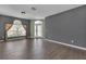 Inviting living room featuring hardwood floors, large windows, and neutral wall colors at 9644 Jasmine Brook Cir, Land O Lakes, FL 34638