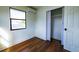 Bedroom with wood flooring, closet and window with view of the outdoors at 9706 N 22Nd St, Tampa, FL 33612