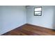 Simple bedroom design with hardwood floors and a large window at 9706 N 22Nd St, Tampa, FL 33612