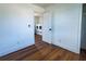 Bright bedroom with wood floors next to laundry room featuring modern washer and dryer at 9706 N 22Nd St, Tampa, FL 33612