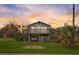 Cozy home with a beautiful sunset view and a well-maintained lawn with space for a car underneath the house at 9706 N 22Nd St, Tampa, FL 33612