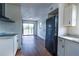 Modern kitchen features a refrigerator, ample cabinet space, sleek countertops, and luxury laminate flooring at 9706 N 22Nd St, Tampa, FL 33612