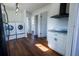 Bright laundry area featuring a washer and dryer hookup, plus a sink, lighting, and luxury laminate flooring at 9706 N 22Nd St, Tampa, FL 33612