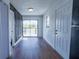 Bright living room features hardwood floors, a sliding glass door, and view of the community pond and the deck at 9706 N 22Nd St, Tampa, FL 33612
