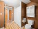 Bathroom featuring tiled floors, a toilet, built-in shelving, and a shower at 10206 N Hyaleah Rd, Tampa, FL 33617