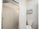 Bathroom featuring a shower with updated tile, pebble floor, and a unique window for natural light at 10206 N Hyaleah Rd, Tampa, FL 33617