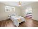Bedroom with hardwood floors, natural light, and a built-in nook for cozy relaxation at 10206 N Hyaleah Rd, Tampa, FL 33617