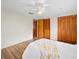 Bedroom with hardwood flooring, ceiling fan, and large closets that offer ample storage at 10206 N Hyaleah Rd, Tampa, FL 33617