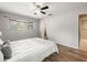 Inviting bedroom with hardwood floors, a ceiling fan, and bright windows at 10206 N Hyaleah Rd, Tampa, FL 33617