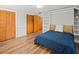 Bedroom with wood flooring, ceiling fan, built-in shelving, and multiple closets for ample storage at 10206 N Hyaleah Rd, Tampa, FL 33617