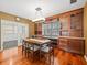 Elegant dining room featuring wood cabinetry and a modern chandelier at 10206 N Hyaleah Rd, Tampa, FL 33617