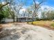Charming two-story home with welcoming front porch, mature trees, and a long driveway at 10206 N Hyaleah Rd, Tampa, FL 33617