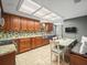 Well-lit kitchen featuring custom cabinetry and a stainless steel sink at 10206 N Hyaleah Rd, Tampa, FL 33617