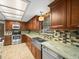 Modern kitchen featuring stainless steel appliances, granite counters and stylish tile backsplash at 10206 N Hyaleah Rd, Tampa, FL 33617