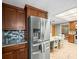 Kitchen with stainless steel refrigerator, dark cabinetry and eating area with natural lighting at 10206 N Hyaleah Rd, Tampa, FL 33617
