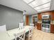 Eat-in kitchen showing modern appliances and access to the living area at 10206 N Hyaleah Rd, Tampa, FL 33617