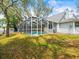 Backyard features a screened pool, storage shed, and fenced yard at 10206 N Hyaleah Rd, Tampa, FL 33617