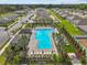 Community swimming pool with abundant seating surrounded by lush vegetation and meticulously maintained lawns at 10433 Alder Green Dr, Riverview, FL 33578
