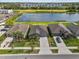 Aerial view of several homes and a pond, showcasing the community and surrounding green spaces at 10433 Alder Green Dr, Riverview, FL 33578