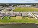 Aerial view of well-maintained homes with green lawns, showcasing the neighborhood's landscaping and proximity to a pond at 10433 Alder Green Dr, Riverview, FL 33578