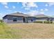 View of home's backyard and exterior, featuring a grassy lawn at 10433 Alder Green Dr, Riverview, FL 33578