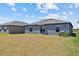 View of home's backyard and exterior with a sliding glass door at 10433 Alder Green Dr, Riverview, FL 33578