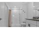 Bathroom with white tiled shower, granite vanity, and modern fixtures at 10433 Alder Green Dr, Riverview, FL 33578