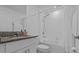 Bright bathroom with granite counters, vanity, white cabinets, and a shower-tub combo at 10433 Alder Green Dr, Riverview, FL 33578
