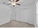Well-lit bedroom featuring a ceiling fan, closet, neutral paint, and carpet at 10433 Alder Green Dr, Riverview, FL 33578