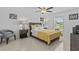 Well-lit bedroom with tiled flooring, ceiling fan, and a view of the lake at 10433 Alder Green Dr, Riverview, FL 33578