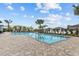 Inviting community pool surrounded by lounge chairs and palm trees, perfect for relaxing and enjoying the outdoors at 10433 Alder Green Dr, Riverview, FL 33578