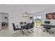 Dining room with a water view from sliding doors and modern chandelier at 10433 Alder Green Dr, Riverview, FL 33578