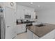 Well-lit kitchen with granite countertops and stainless steel appliances at 10433 Alder Green Dr, Riverview, FL 33578