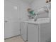 Functional laundry room with a washer, dryer, and shelving at 10433 Alder Green Dr, Riverview, FL 33578