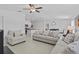 Open-concept living room with tile floors and comfortable seating at 10433 Alder Green Dr, Riverview, FL 33578