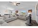 Spacious living room featuring tile flooring, comfortable sofas, and a ceiling fan at 10433 Alder Green Dr, Riverview, FL 33578
