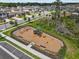 Aerial view of a playground equipped with swings, slides, and various structures ensuring hours of entertainment at 10433 Alder Green Dr, Riverview, FL 33578