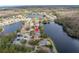 Stunning aerial view of the community and the home's location on the lake with mature tree coverage at 10506 Sky Flower Ct, Land O Lakes, FL 34638