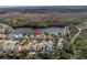 Aerial view of a home with a lake view in a suburban neighborhood at 10506 Sky Flower Ct, Land O Lakes, FL 34638