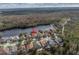 An aerial view that highlights the home's premium location in a scenic lakeside community with lush surroundings at 10506 Sky Flower Ct, Land O Lakes, FL 34638